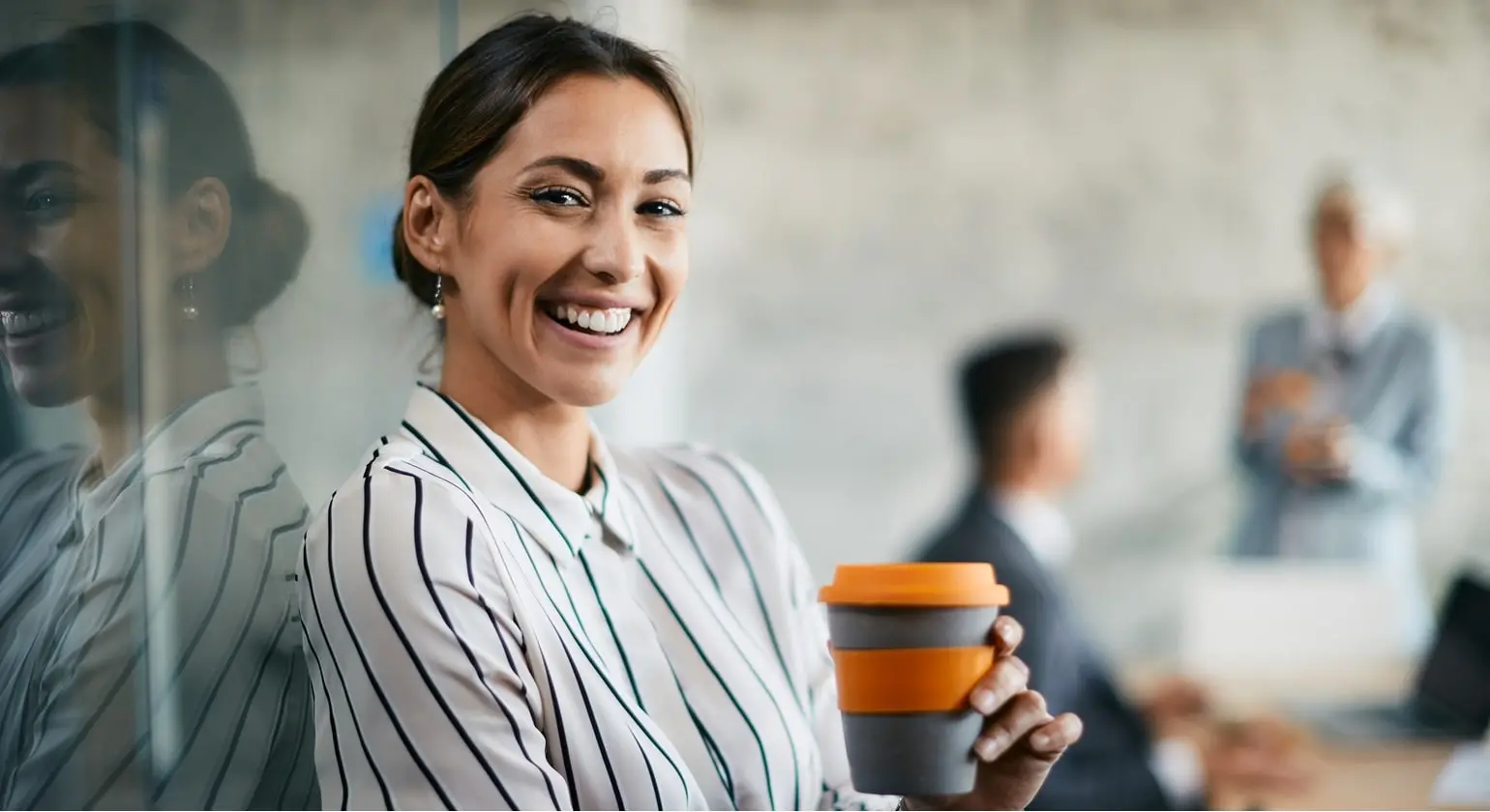 Advertise Jobs for free A business women is happy after her job interview and drinks a cup of coffee